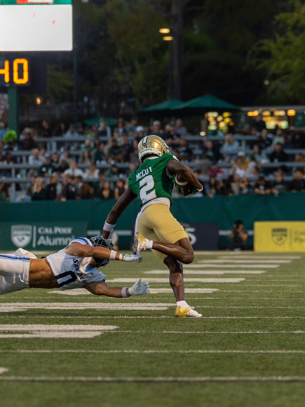 Cal Poly wide receiver Tayvion McCoy stiff-arms San Diego Toreros safety Ian Harrison at Mustang Memorial Field on Sept. 19, 2026. The Mustangs lost to the Toreros 38-35 on Homecoming night on a last-minute field goal.